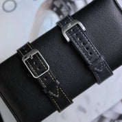 Black buttero strap with beige stitches and gray alligator watch strap with light stitches, both with RSM buckle and deployment clasp, showcasing fine stitching.