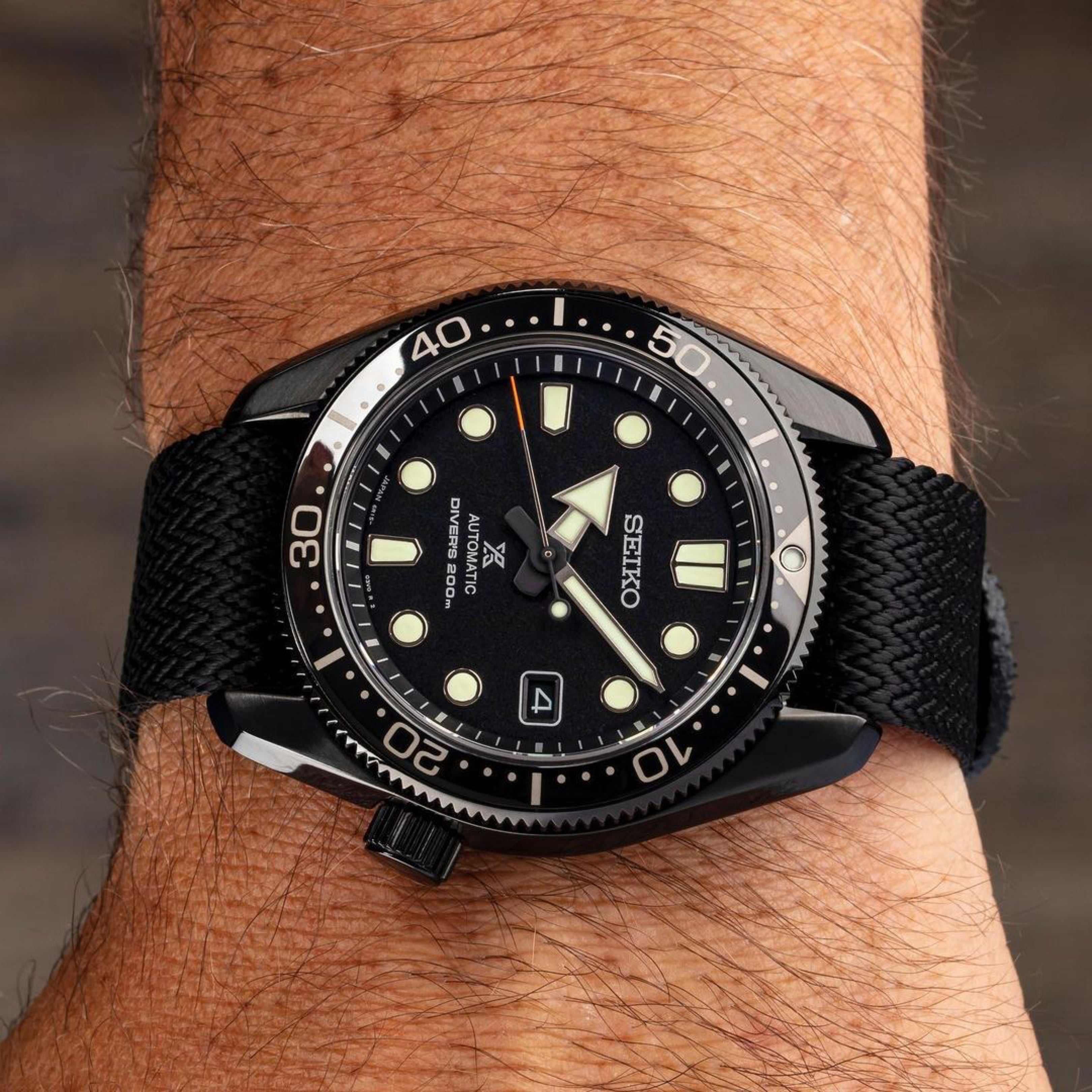 Seiko Prospex Diver 200 Topper LE (SPB107) with a hard black-coated case on RSM Herringbone Artillery Black strap, wrist-worn.