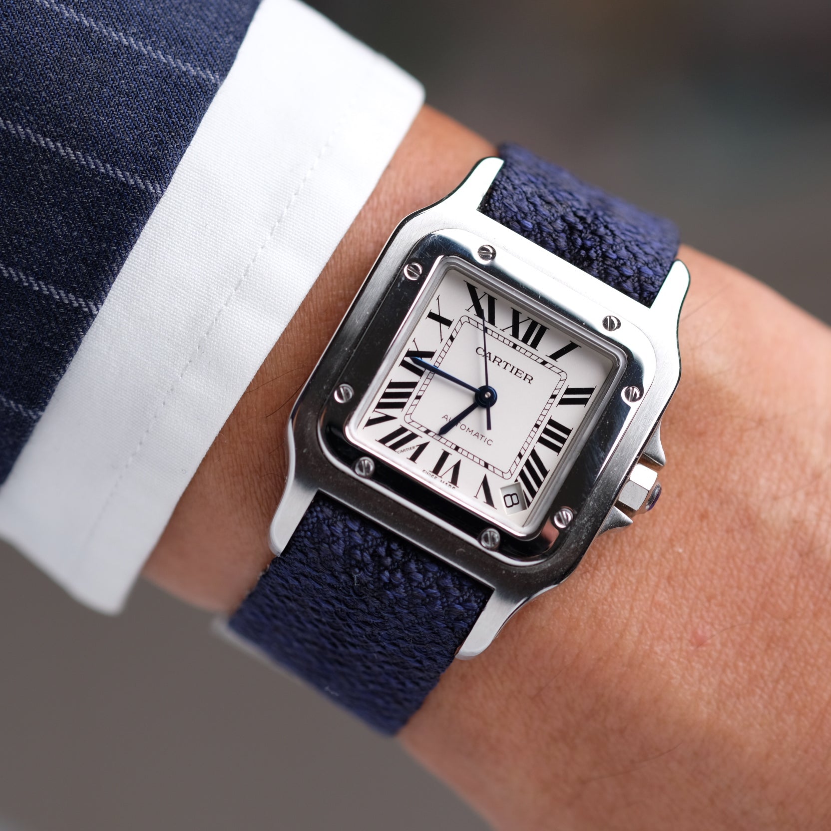 Cartier Santos paired with Blue Reversible Silk Single Pass by RSM Watch Strap, worn on a man’s wrist in a suit.