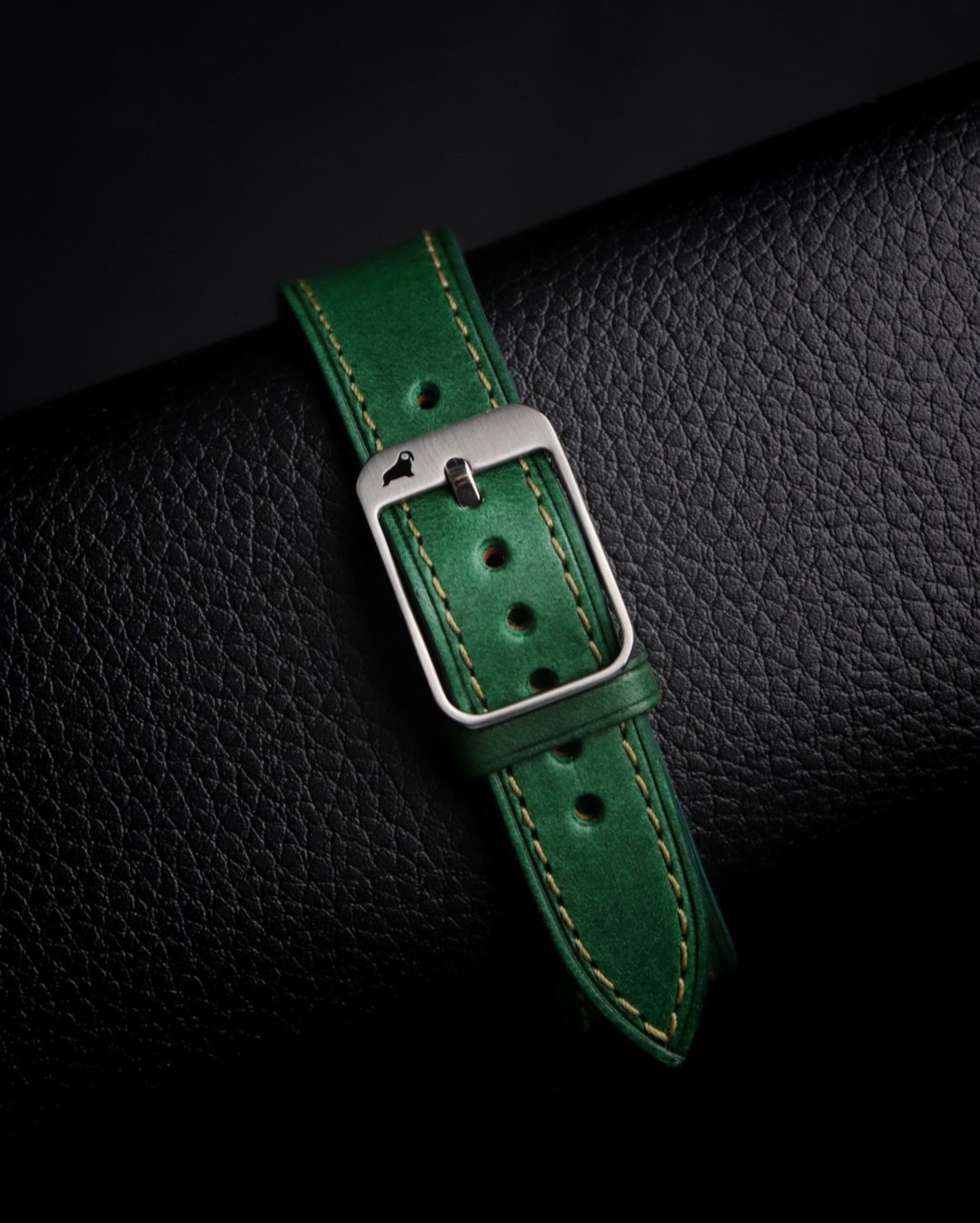 Green Buttero leather strap with RSM 316L stainless steel buckle, clean punched holes, and a beautiful stretched bent leather section.