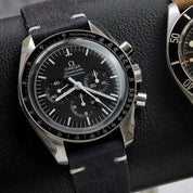 Omega Speedmaster watch paired with RSM's Black Coal Fine Canvas strap, featuring white stitching details for a sleek, stylish look.