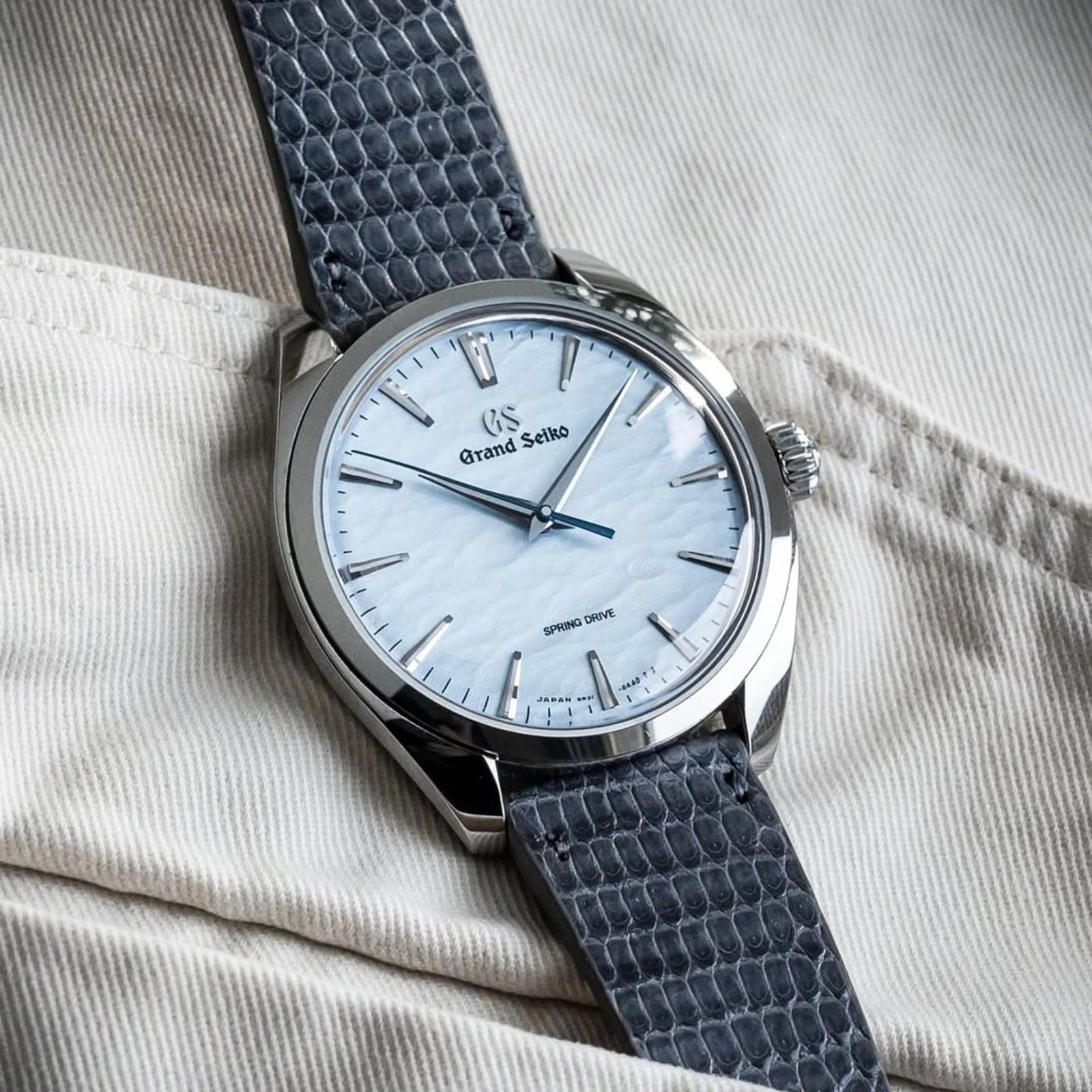 RSM's grey leather lizard strap fits the Grand Seiko Omiwatari with a baby blue dial, complementing the dial's light blue tones.