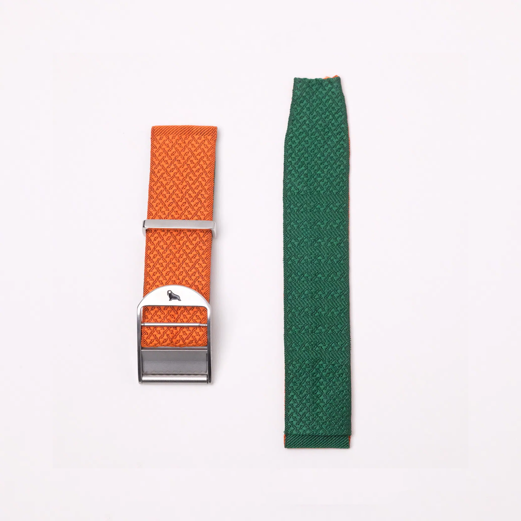 The 2-Piece Silk Strap set includes an orange strap with a silver buckle and a green strap with a subtle geometric pattern, displayed on a plain background.