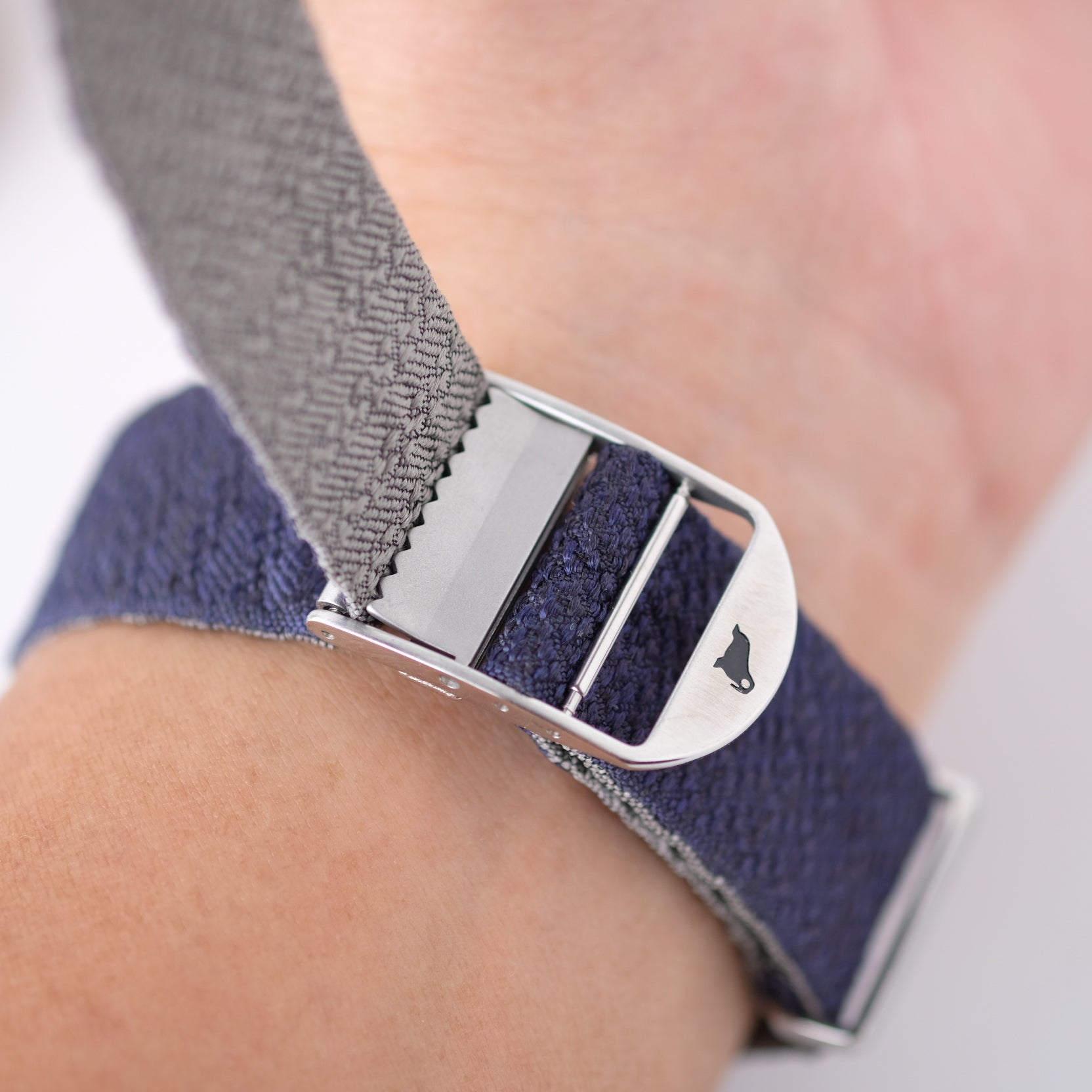 A ladder buckle with a clamp system for RSM reversible silk straps, offering endless micro adjustments to fit all wrist sizes.