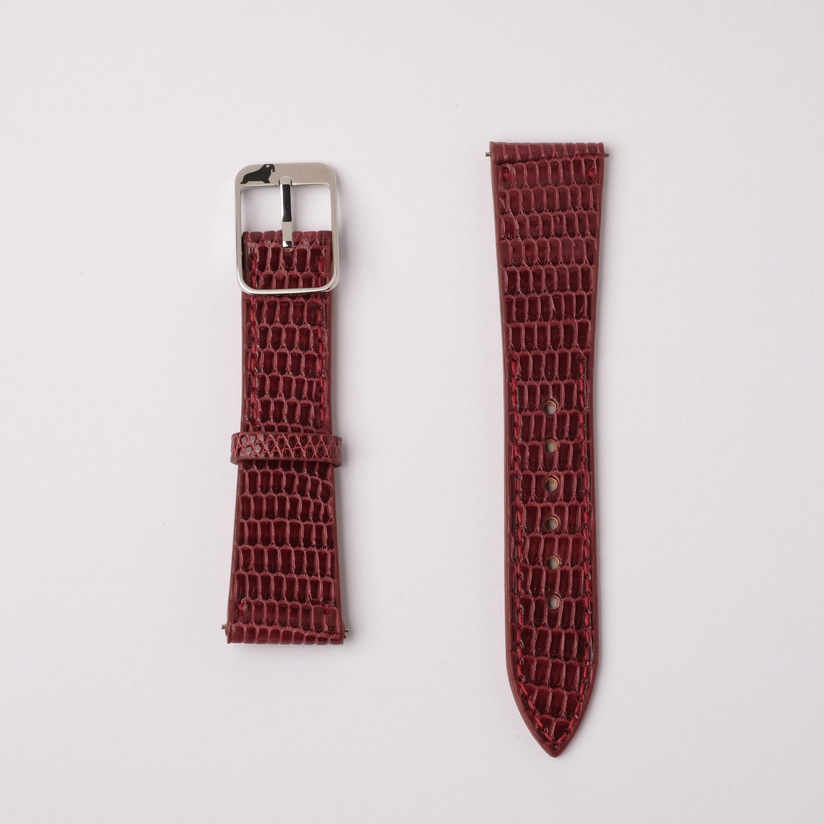 A set of burgundy Spanish Lizard leather watch straps by RSM, featuring natural grains. One with a stainless steel buckle, the other pointed with holes.