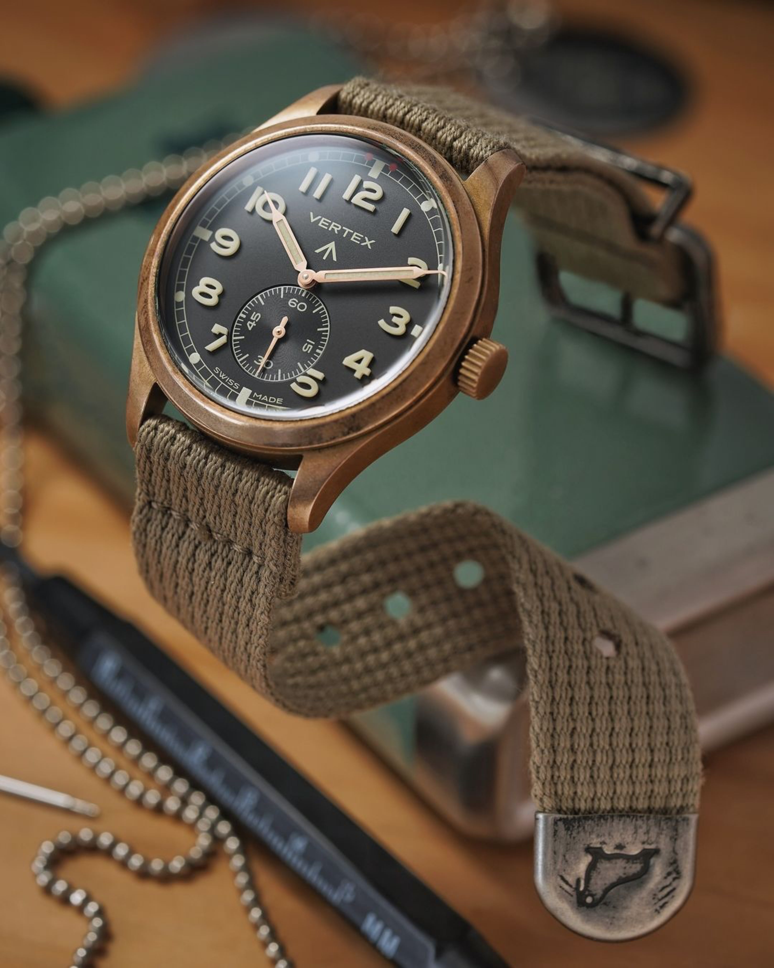 Vertex Bronze watch fitted on RSM vintage military cotton strap with distressed hardware. End tips shows RSM's walrus logo. 